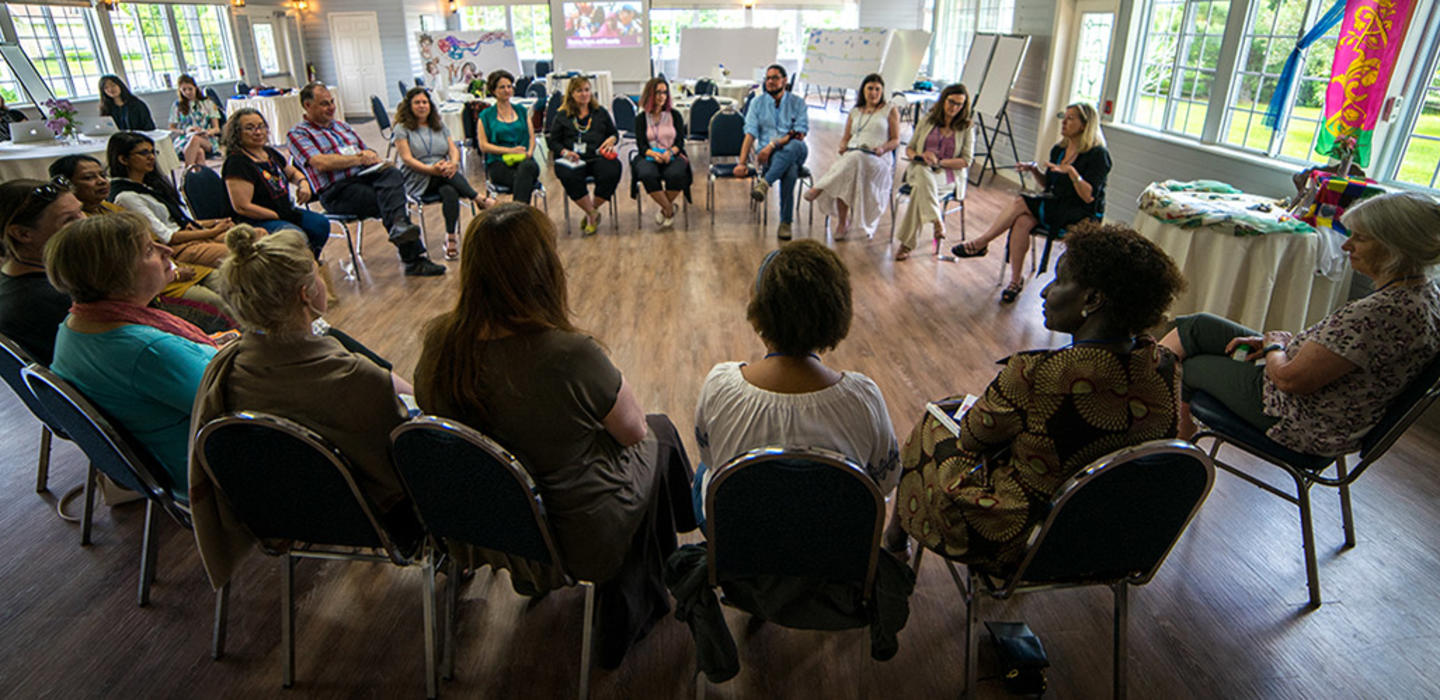 Participants sitting in a semi circle discussing