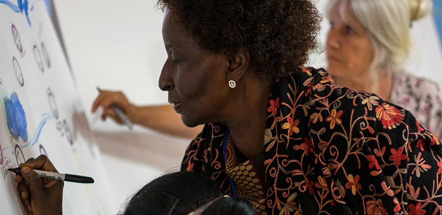 Women writing on a white board