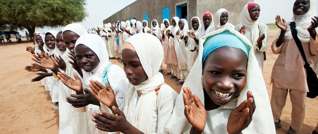  Girls celebrate the opening of a new school and clinic implemented by the African Union–UN Hybrid Operation in Darfur. Photo by UN Photo/Albert González Farran