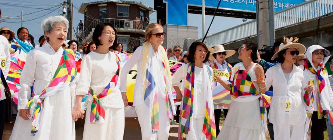  Participants of the Women Cross DMZ march, including Christine Ahn and Gloria Steinem, after crossing the DMZ along the southern border; Photo Credit - Niana Liu