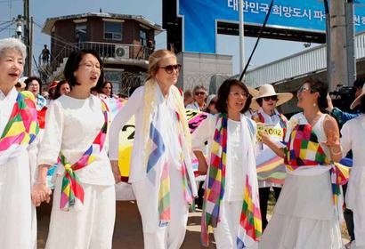  Participants of the Women Cross DMZ march, including Christine Ahn and Gloria Steinem, after crossing the DMZ along the southern border; Photo Credit - Niana Liu